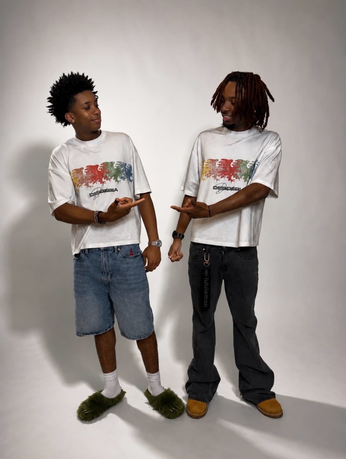 Two models in the Family tee pointing at each other in studio