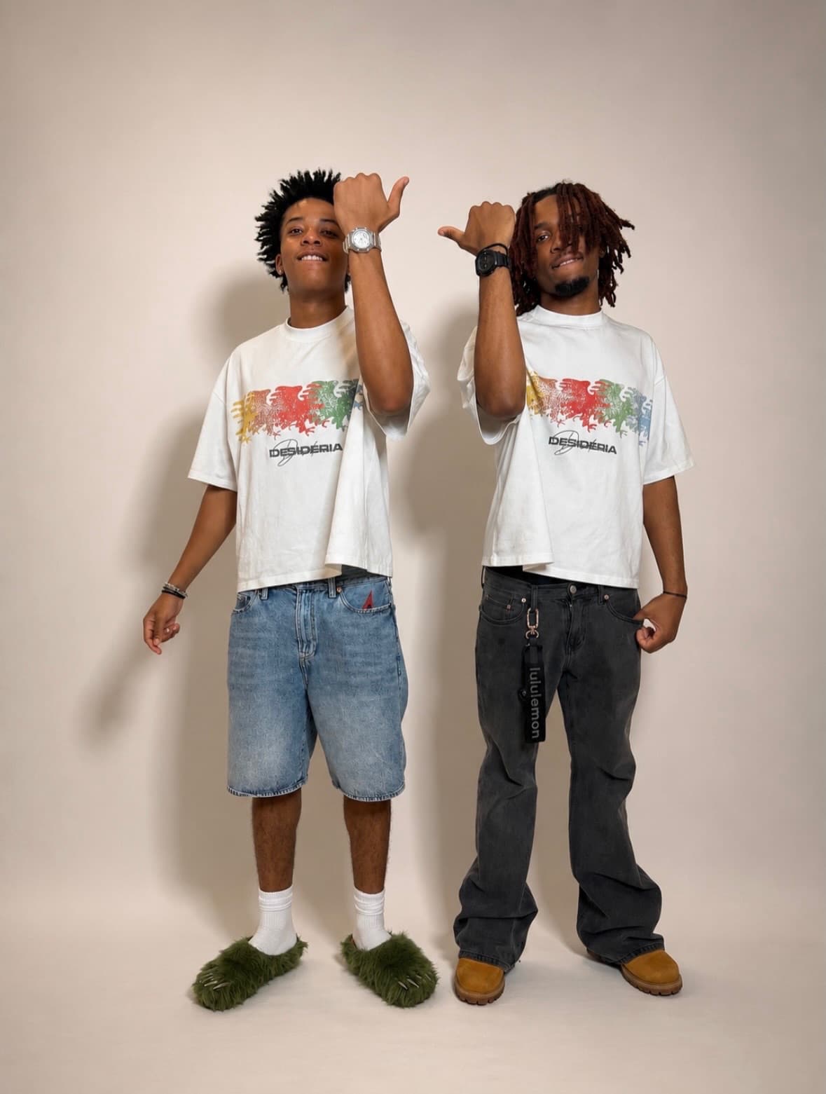 Both models throwing thumbs in the multicolor eagle tee