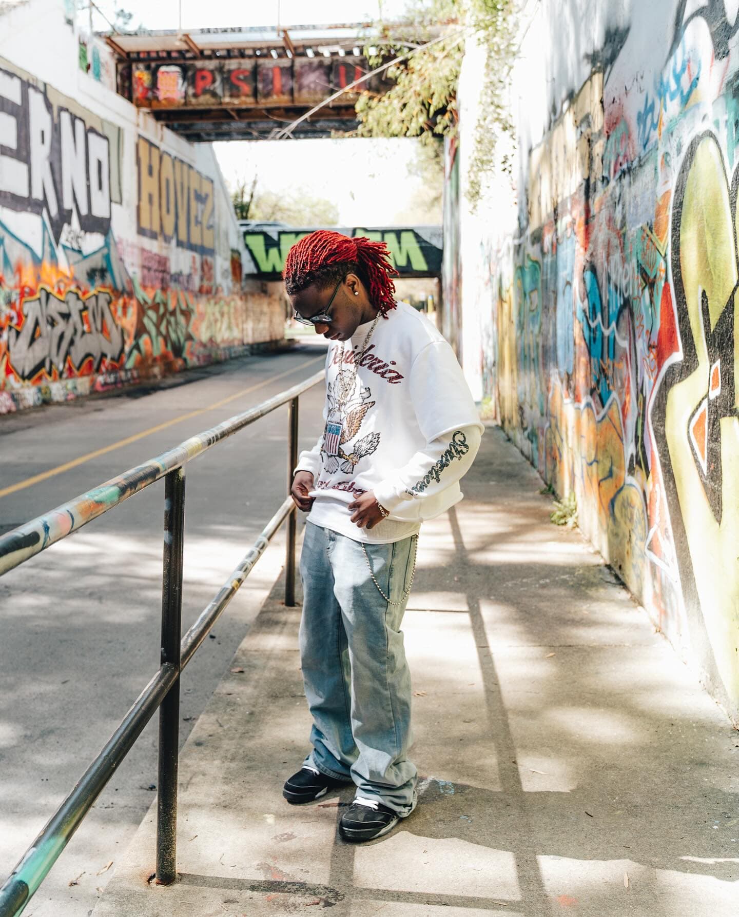 Tucking the double sleeve into denim, chain swinging