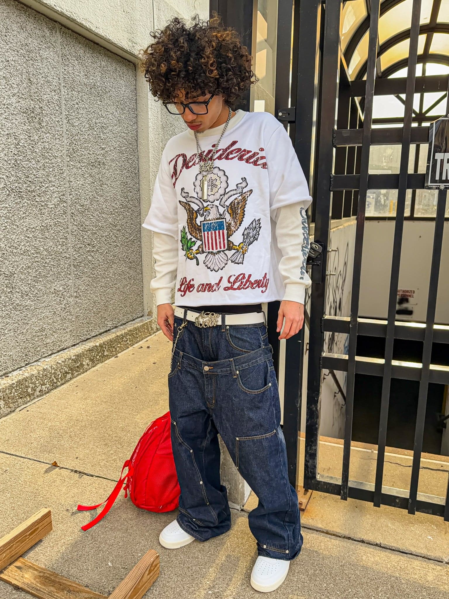 Life & Liberty double sleeve worn at an iron gate, front crest in view